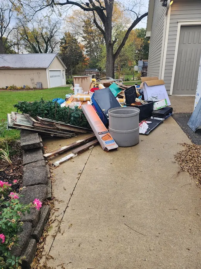 Dumpster being loaded with debris for 10 Yard Dumpster Rental in Bel Aire